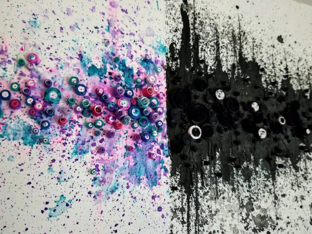 An abstract mixed-media painting with vibrant splattered colours transitioning into dark tones
