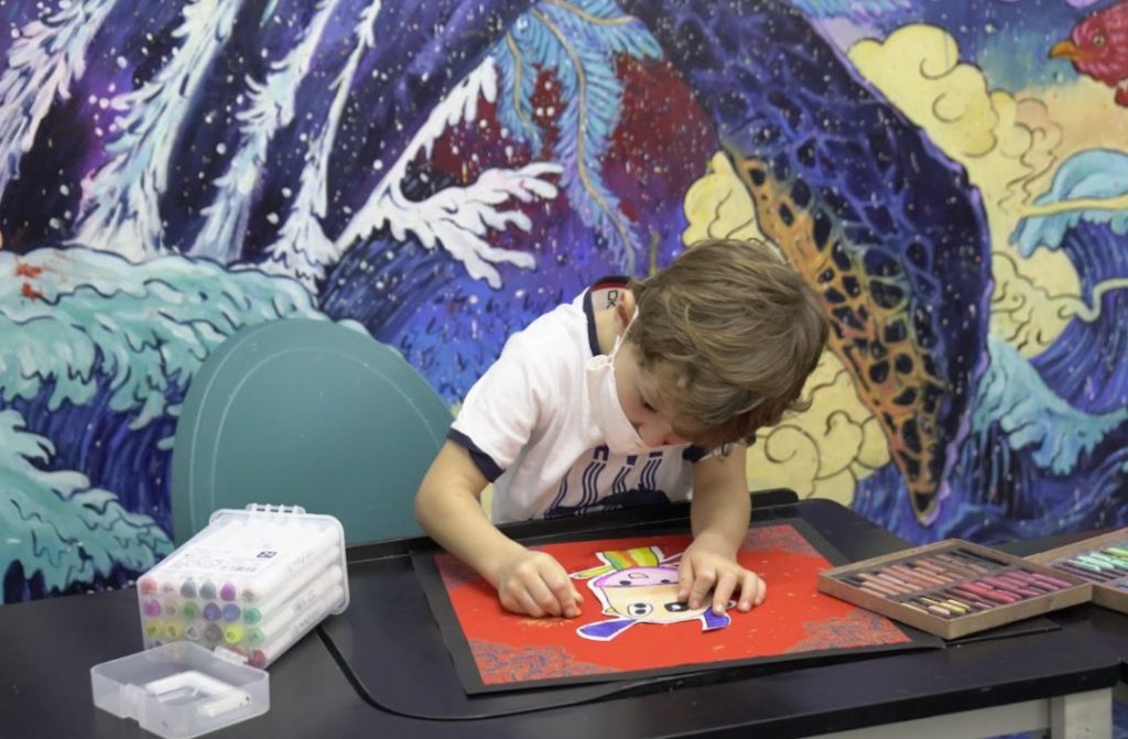 Children of different ages taking part in art activities suited to their developmental stage
