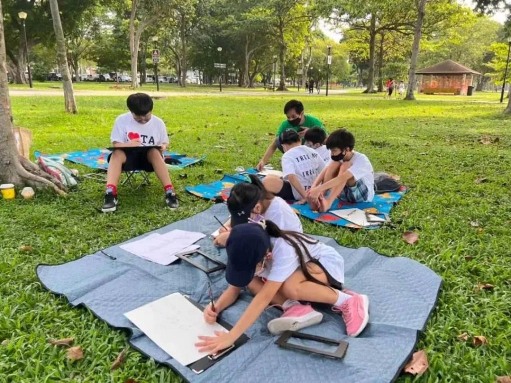 Child trying out a variety of art materials in a supportive classroom setting