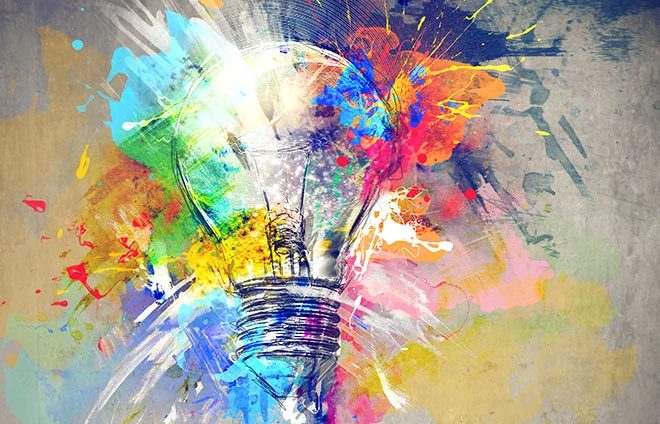 Hand-drawn lightbulb sketch bursting with colourful paint splashes, symbolising creative ideas