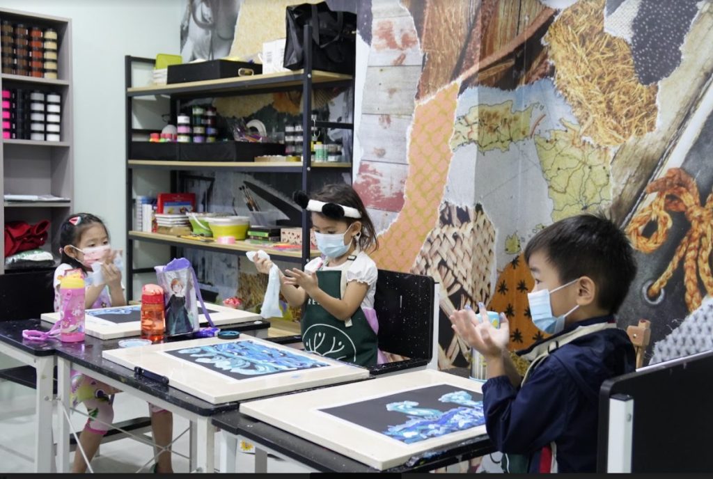 Children in a warm, inclusive Tree Art classroom environment