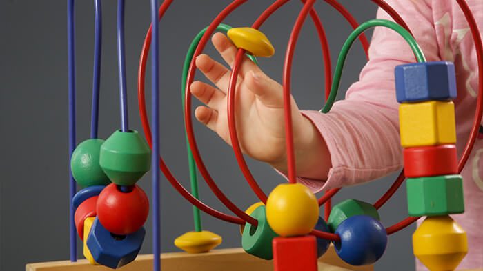Child practicing hand-eye coordination while working with art tools and materials