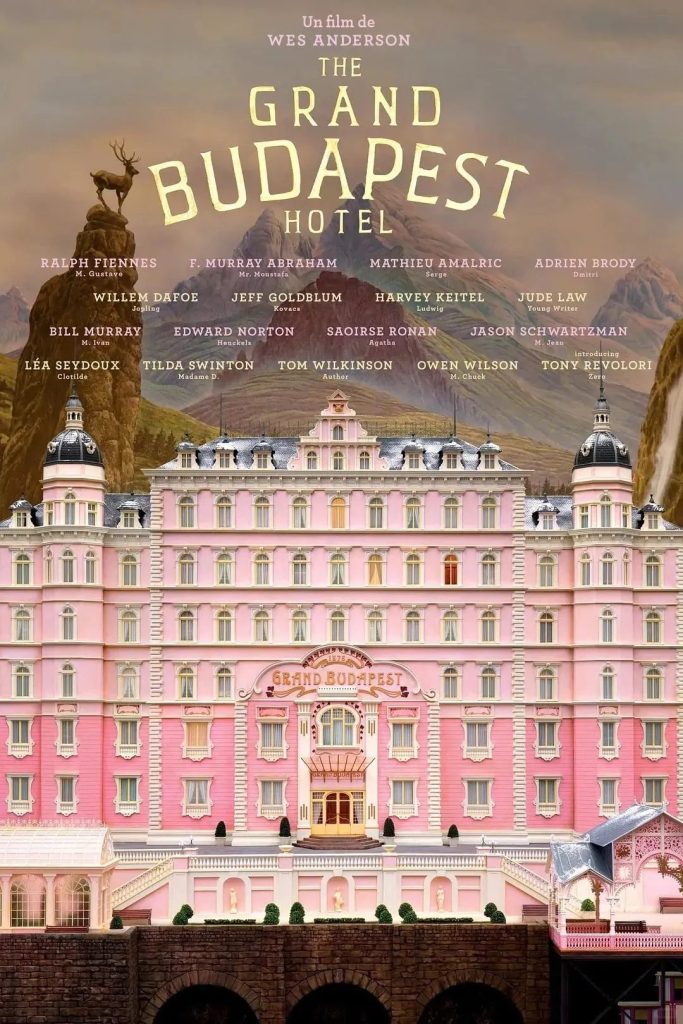 Film poster for Wes Anderson's The Grand Budapest Hotel, showing the pink hotel perched in the mountains