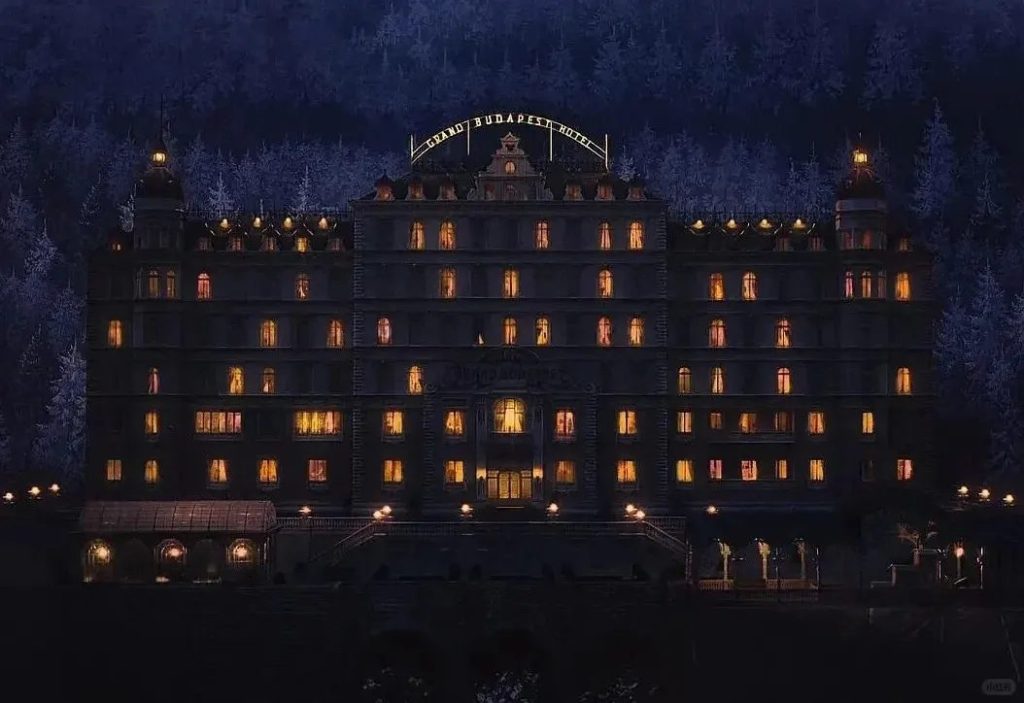 Still from The Grand Budapest Hotel showing a girl standing in the snow holding a book, framed symmetrically