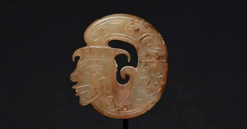 Detail of the Sanxingdui bronze snake's surface pattern, showing the abstract bird-wing motif known as the Chi Yu Pattern