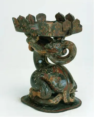 Lacquered wooden Xuanwu figure combining a turtle's body with a coiled snake, topped with an antler-shaped crown