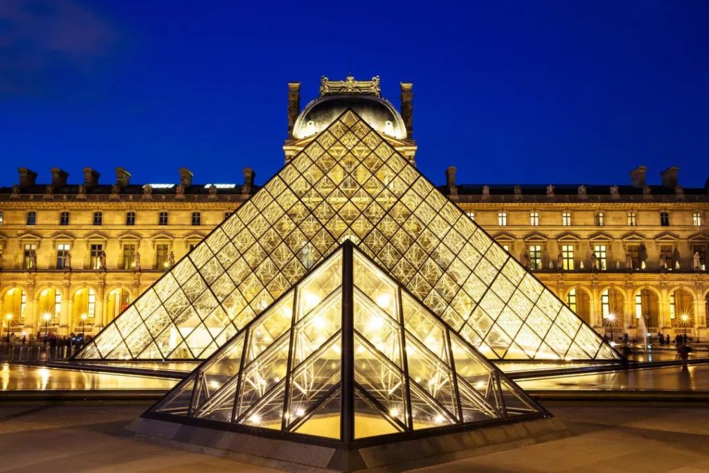 The illuminated glass pyramid at the Louvre Museum in Paris at night