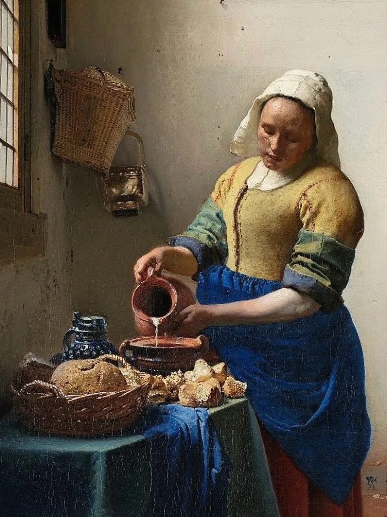 Johannes Vermeer's The Milkmaid, softly lit by daylight from a window on the left
