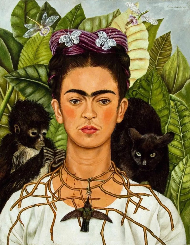 Frida Kahlo self-portrait wearing a thorn necklace with a hummingbird pendant, flanked by a monkey and a black cat amid green leaves