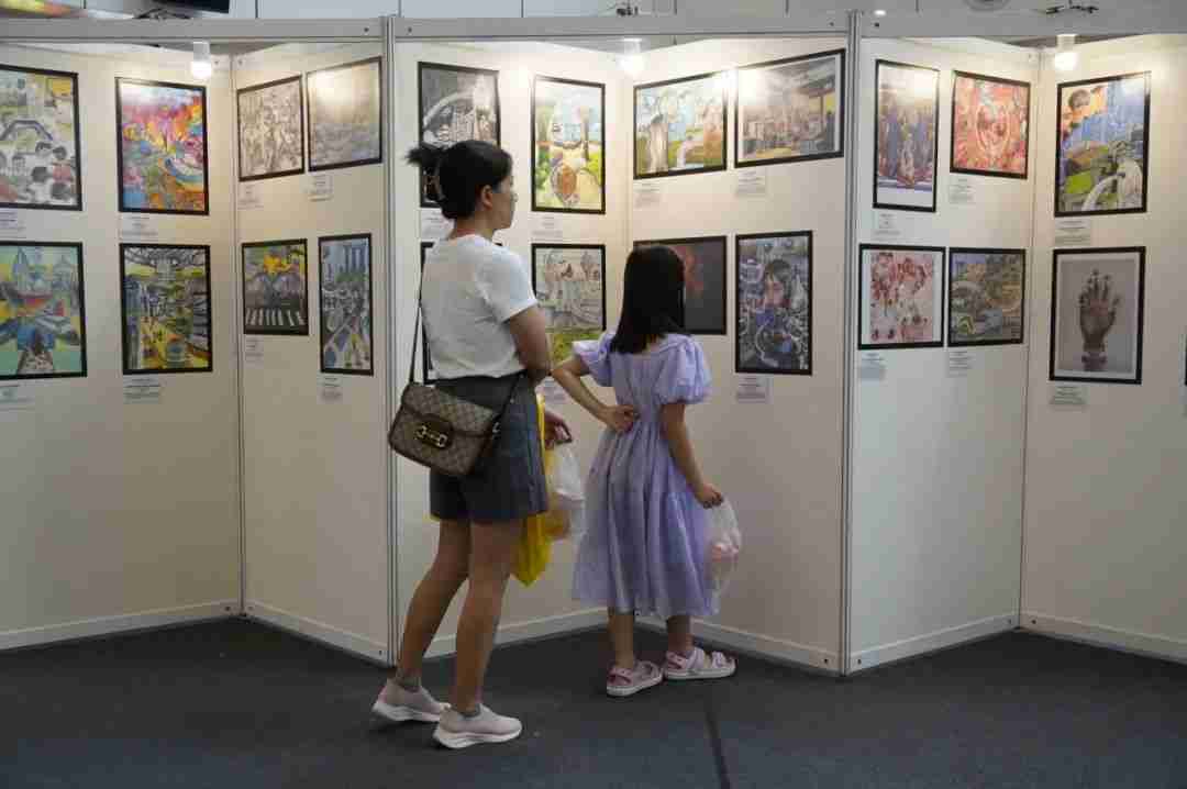 Visitors viewing the artwork exhibition on display at United Square