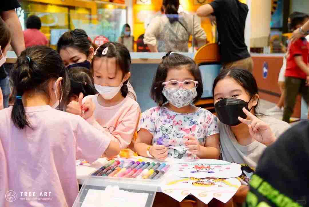 Children drawing together with markers at a TreeArt community art event