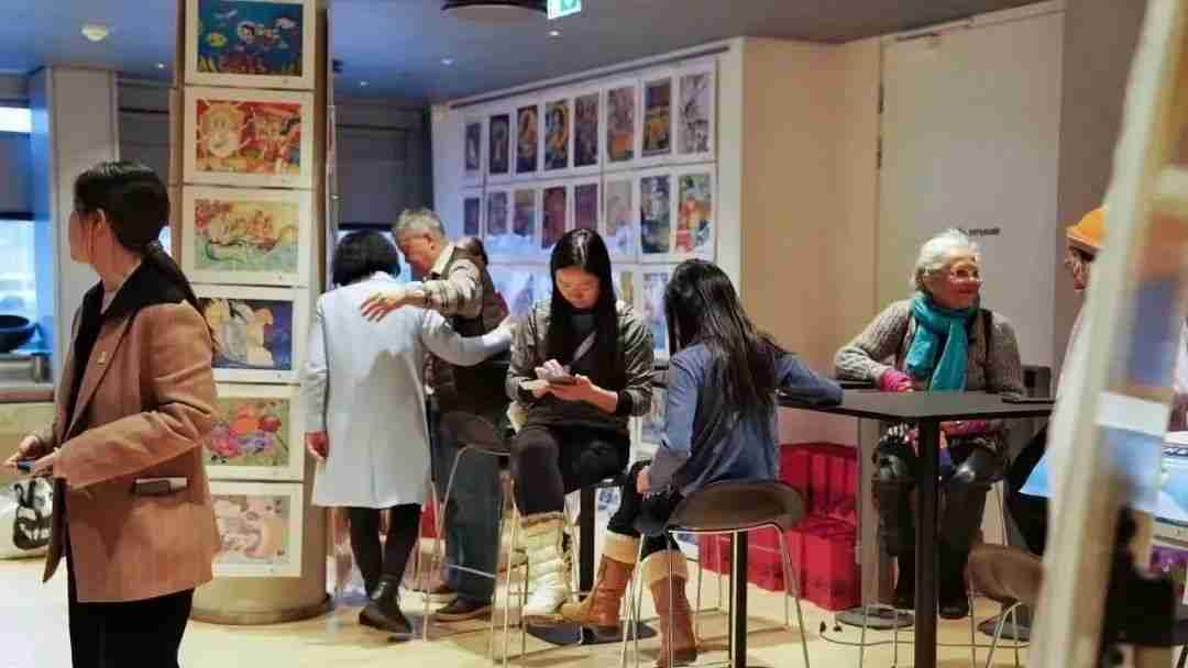 Visitors gathered near displayed artworks at the 2023 Andersen International Art Exhibition at the Danish Royal Library
