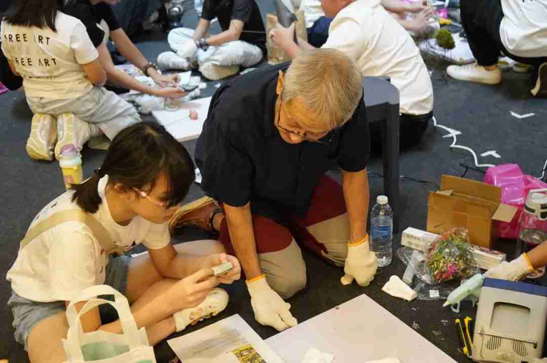 Photo of winners receiving feedback from an art master