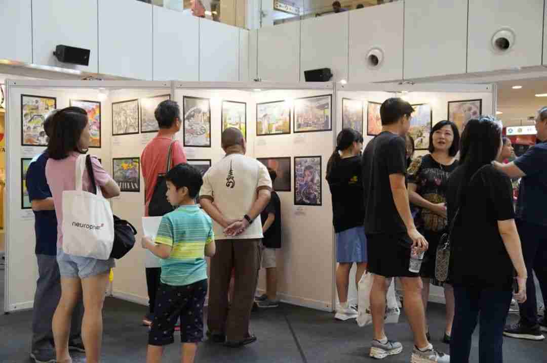 Visitors browsing the exhibited artworks displayed in the United Square atrium