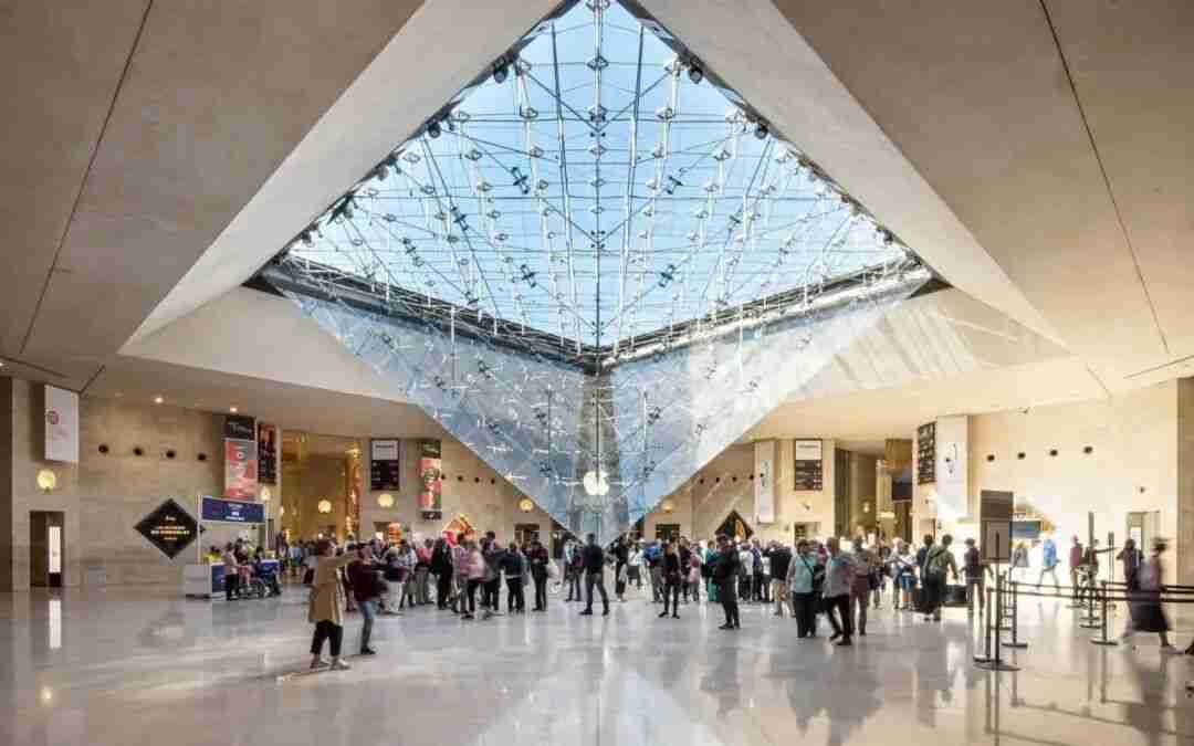 Visitors gathered beneath the inverted glass pyramid inside the Carrousel du Louvre exhibition hall