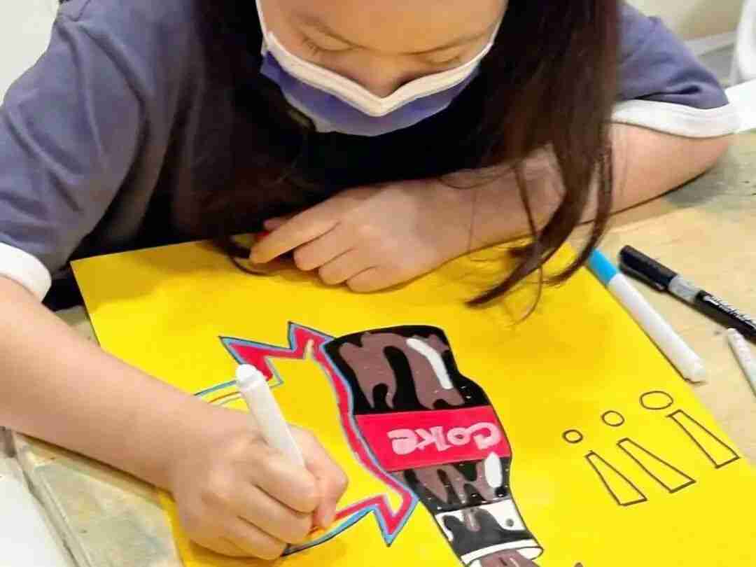 A child closely observing a subject while sketching during a TreeArt class