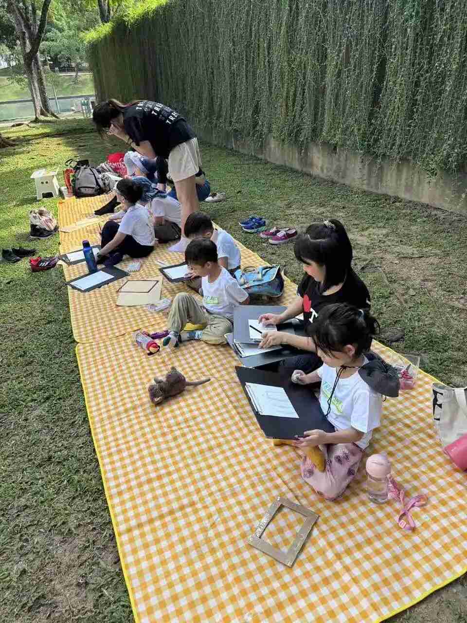 A child proudly holding their finished outdoor sketch