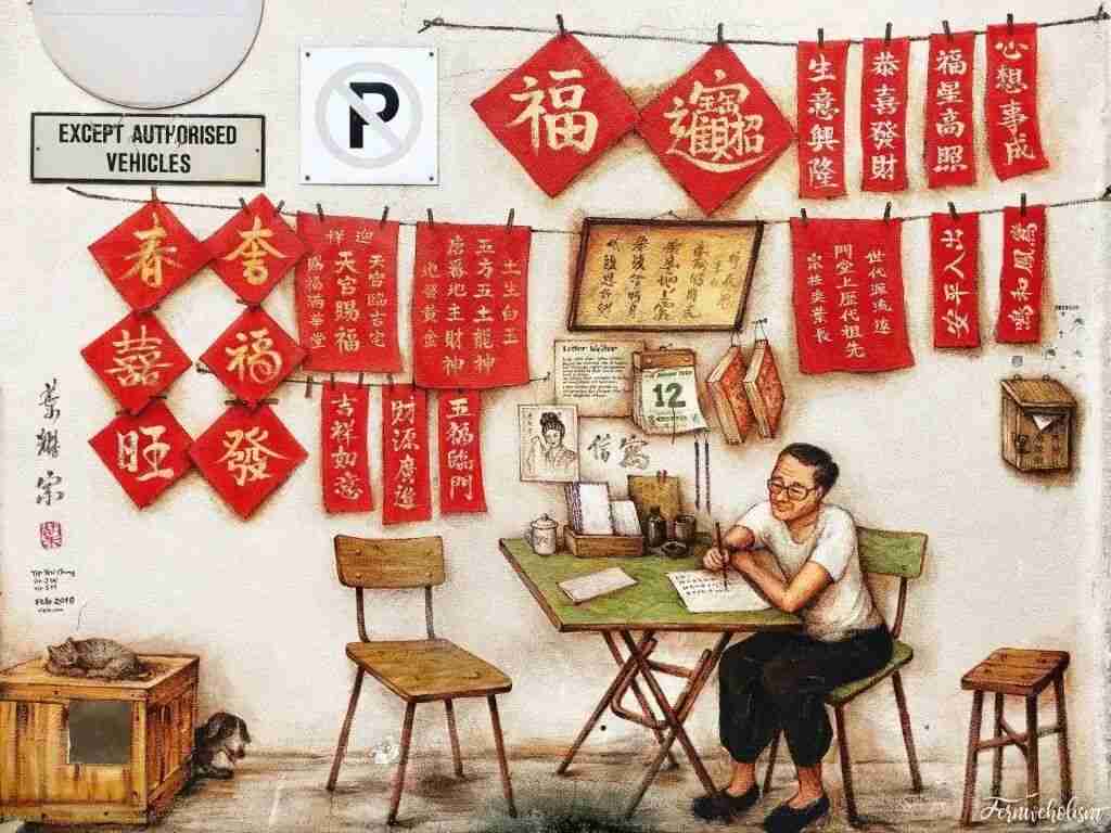 Mural by Yip Yew Chong depicting a Chinatown calligrapher writing New Year couplets beneath rows of hanging red decorations.