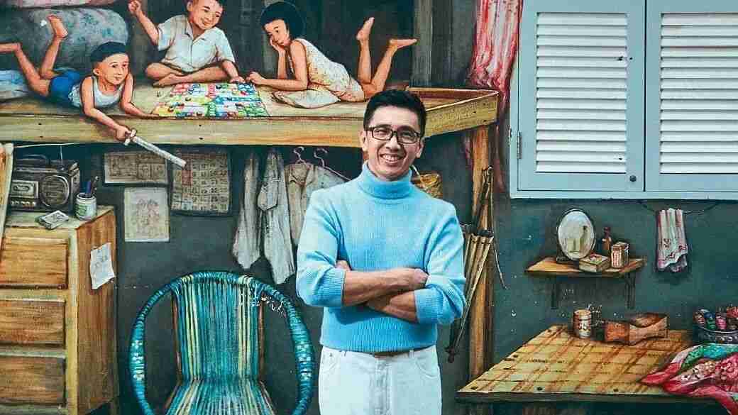 Portrait of judge Mr Yip Yew Chong standing in front of one of his nostalgic Singapore murals.