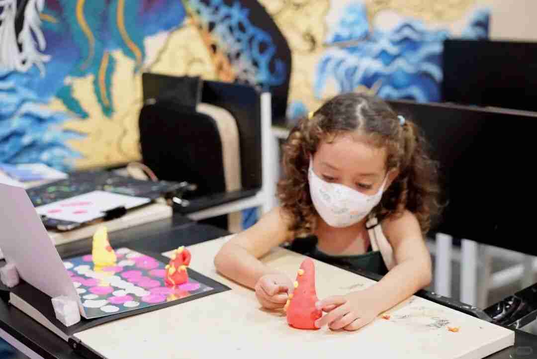 A TreeArt student working on a clay sculpture in class