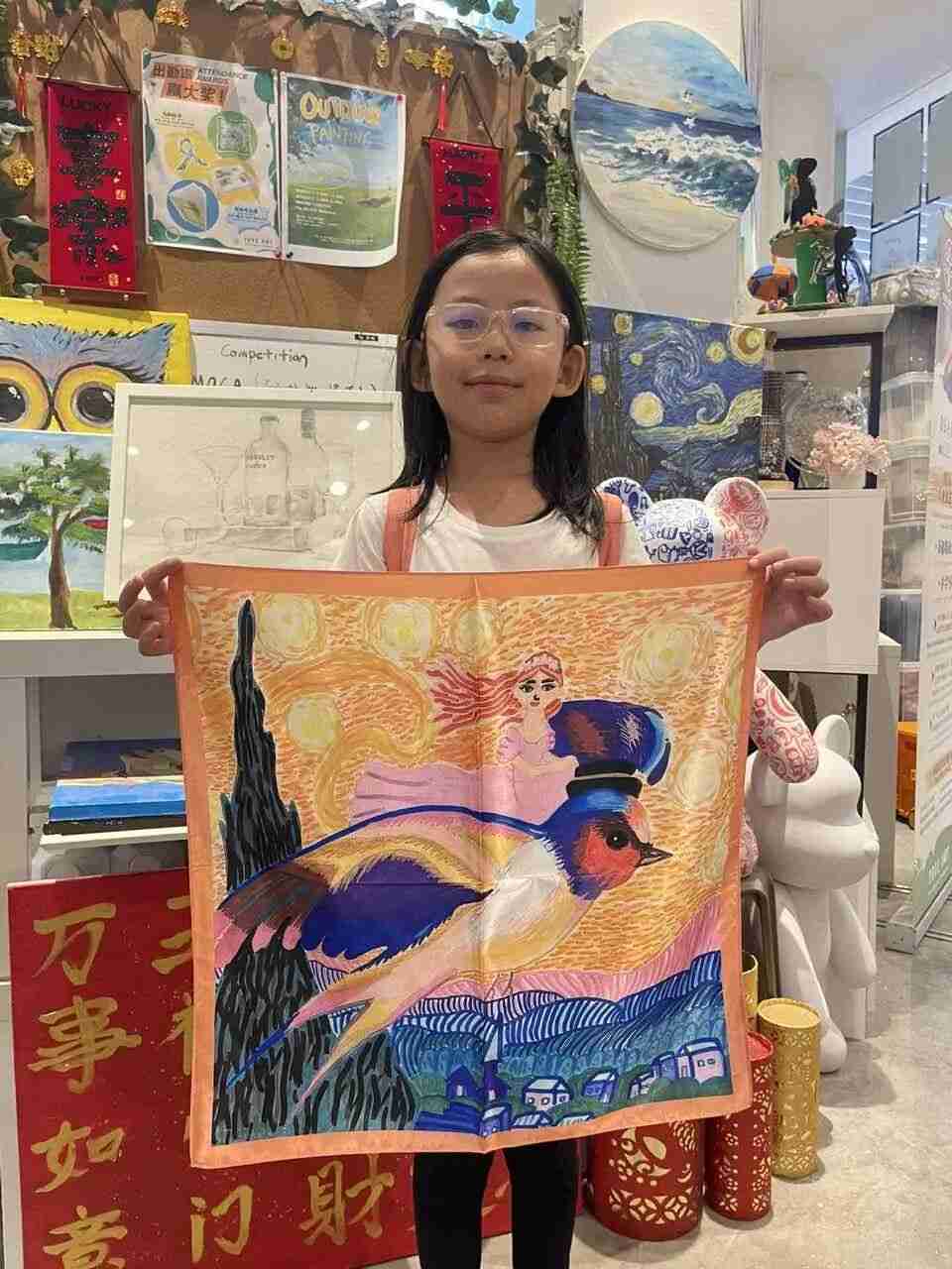 TREE ART student proudly displaying their hand-painted silk scarf design