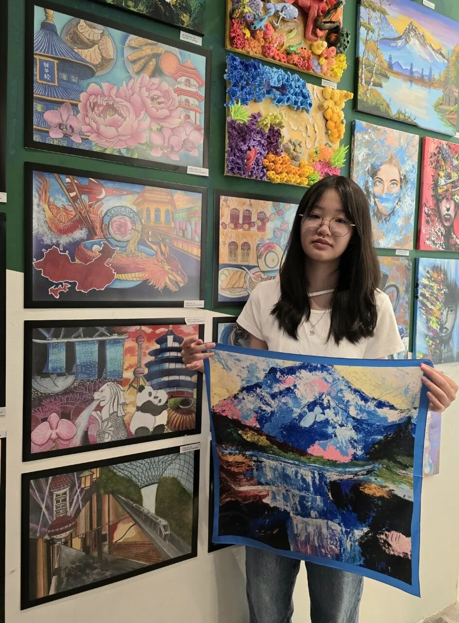 Child's original scarf design shown framed on a wall