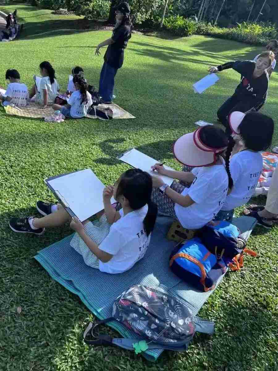 A child observing and sketching the natural world outdoors