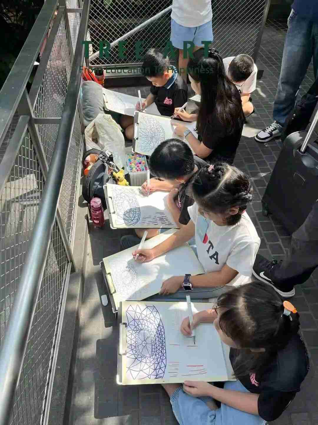 A young artist patiently working on a painting during a TreeArt class