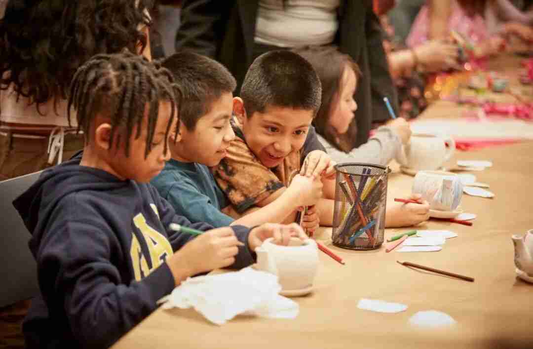 Children creating art together at a workshop table