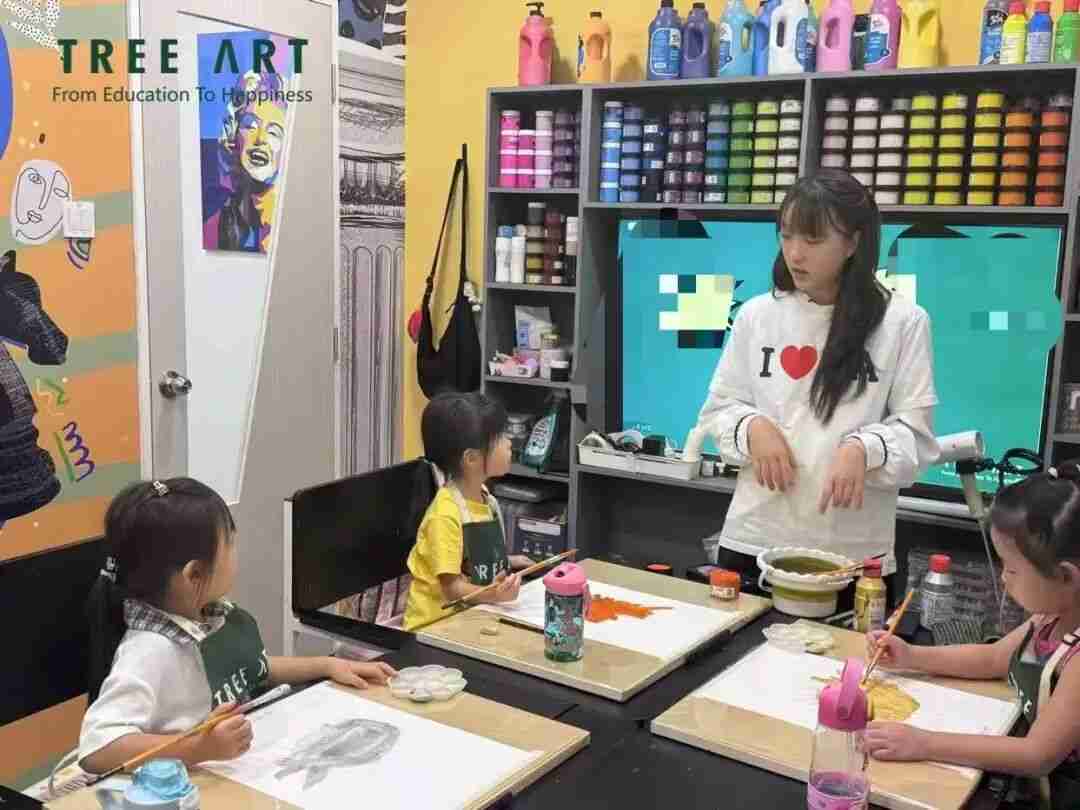 A TreeArt teacher guiding young students during a painting class