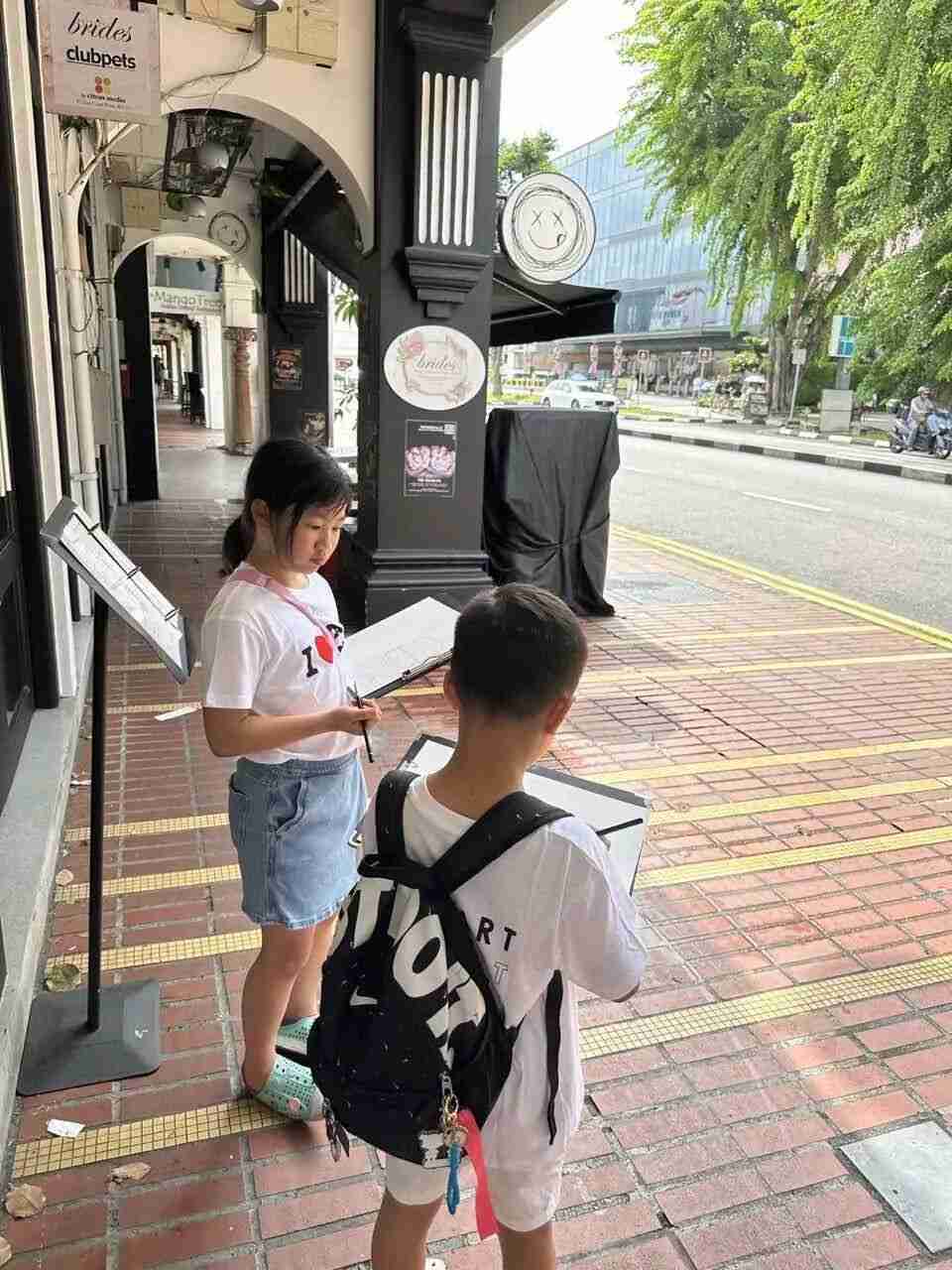 A child sketching a city scene, part of a dialogue between child and urban landscape