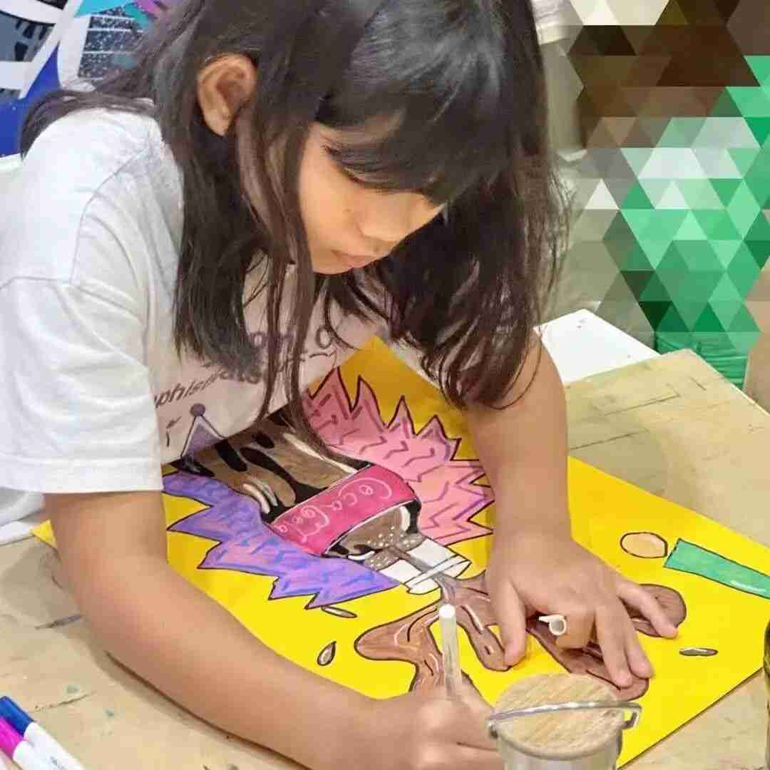 Child concentrating while painting a bold, pop-art style illustration of a bursting soda can