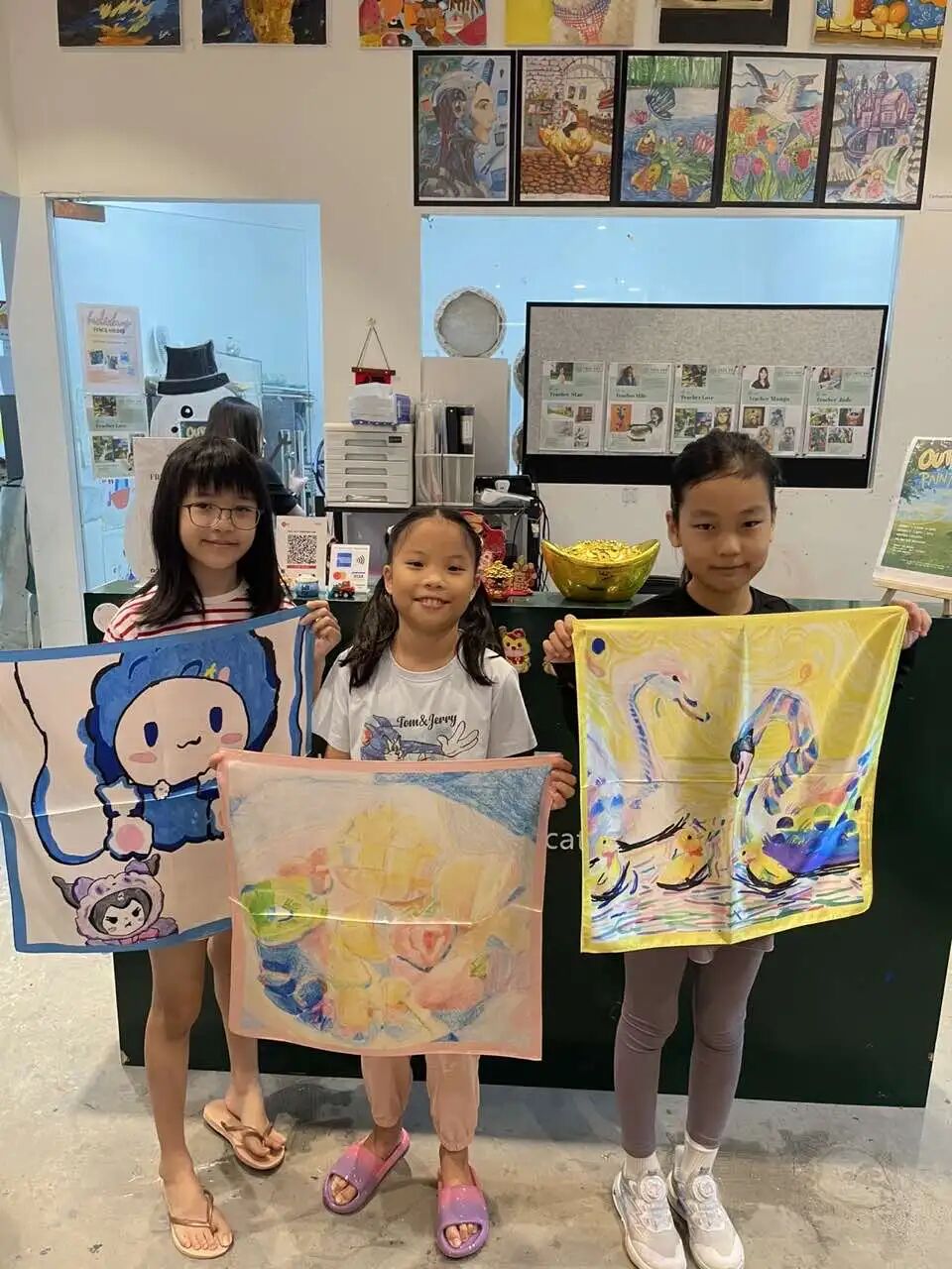Young designer celebrating their completed scarf artwork
