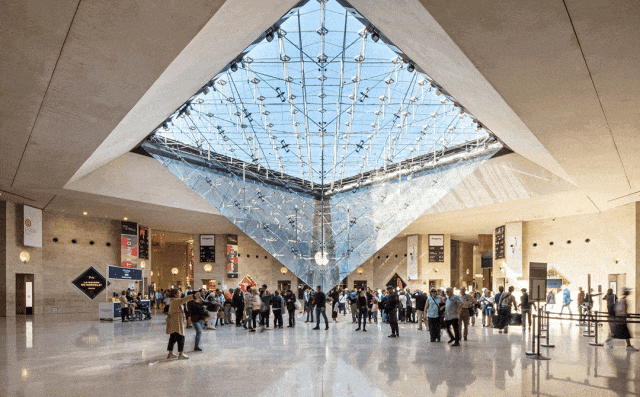 Visitors inside the Carrousel du Louvre beneath the inverted glass pyramid