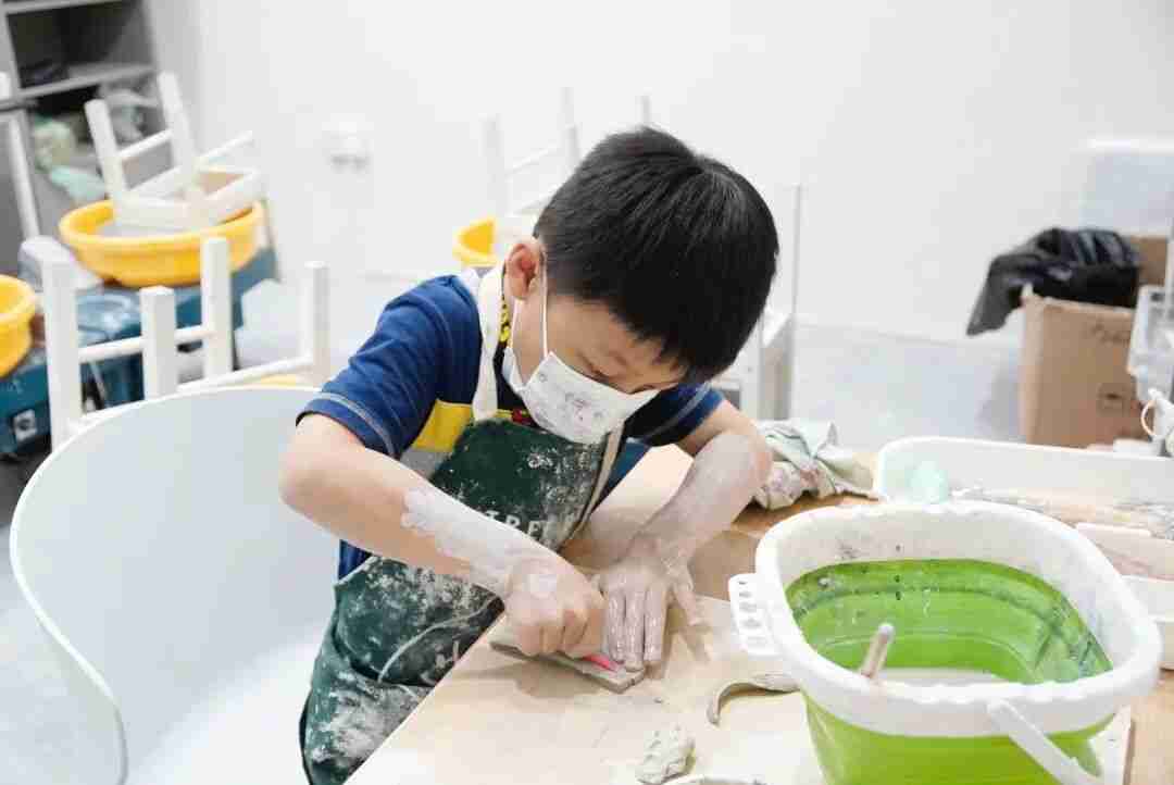 A TreeArt student shaping clay with his hands in Ceramics and Sculpture class