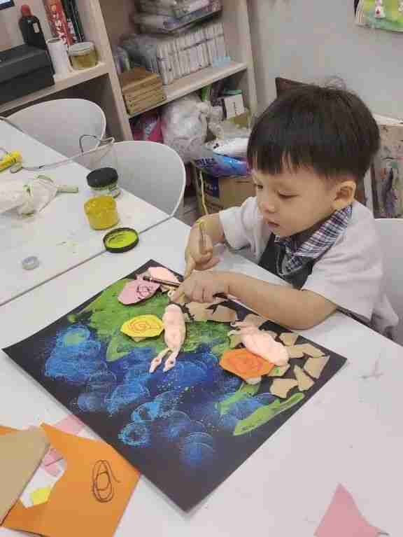 A TreeArt student displaying their artwork in class