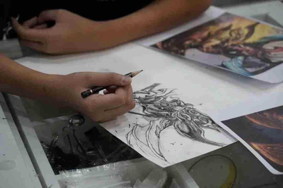 A child concentrating closely on a drawing during a TreeArt class