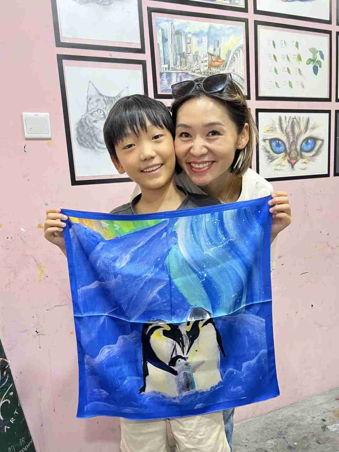 Close-up of a mother proudly wearing her child's scarf design