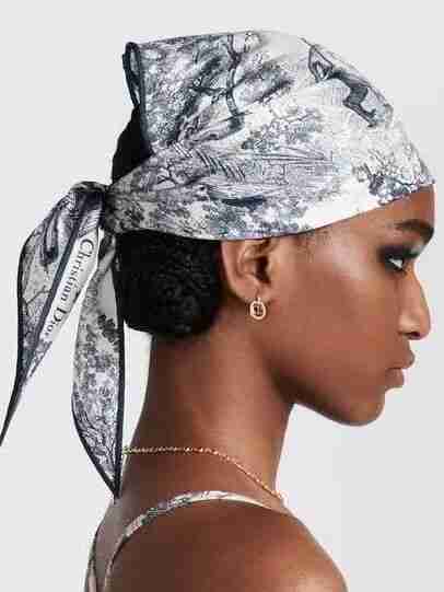 Model wearing a Christian Dior silk scarf tied as a headscarf