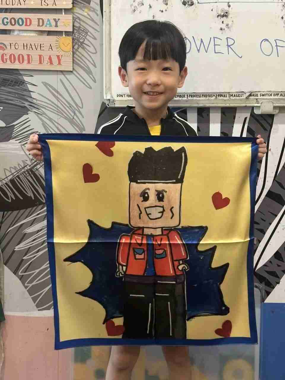 TREE ART student holding up their finished scarf artwork