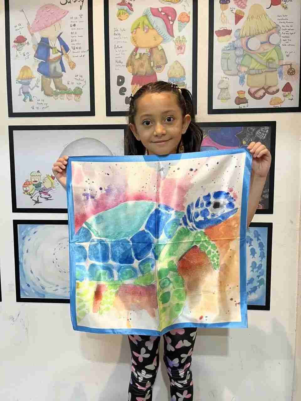 TREE ART student beaming while showing their silk scarf creation