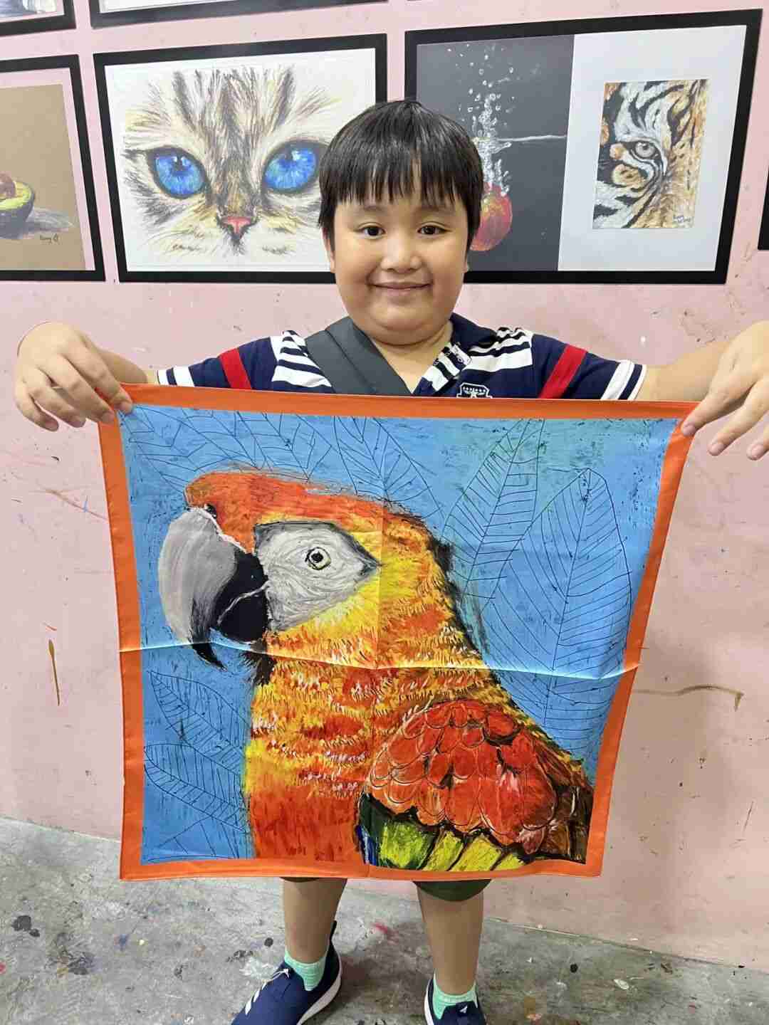 TREE ART student holding their finished silk scarf creation