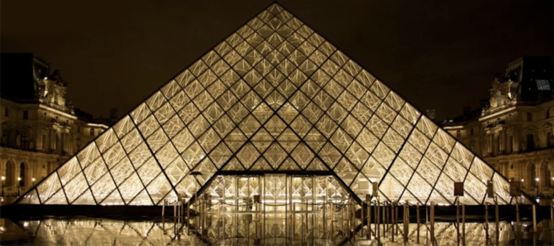 The illuminated glass pyramid of the Louvre Museum at night
