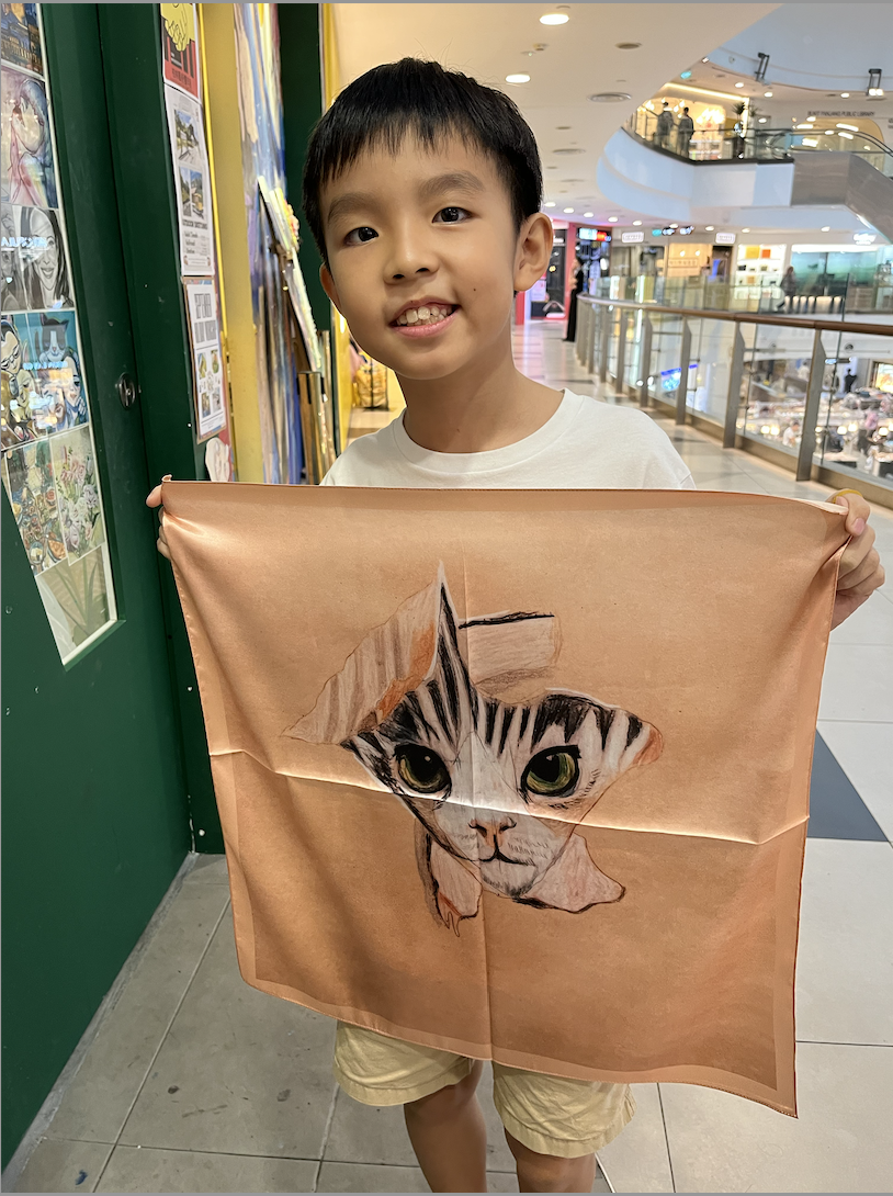 Close-up of a child's imaginative brushwork on silk