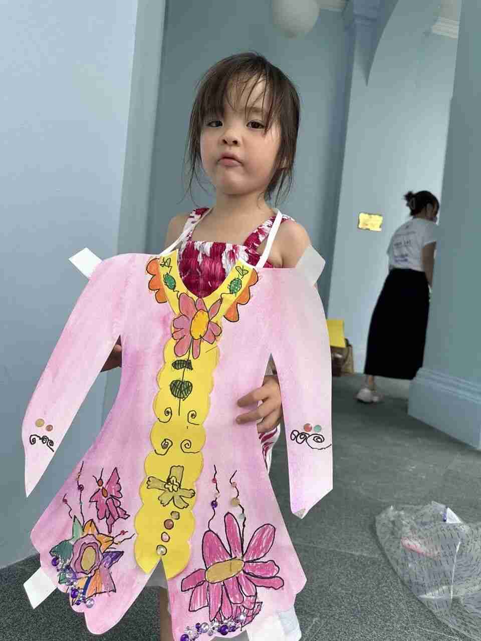 A TreeArt student proudly presenting their finished artwork in class