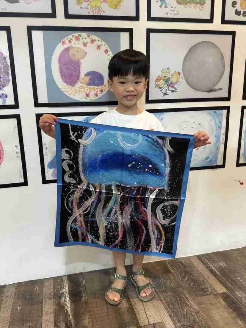 Mother smiling while wearing a silk scarf her child created
