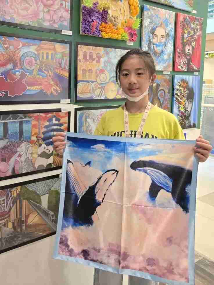 Child painting a fantastical story onto fabric for their scarf design