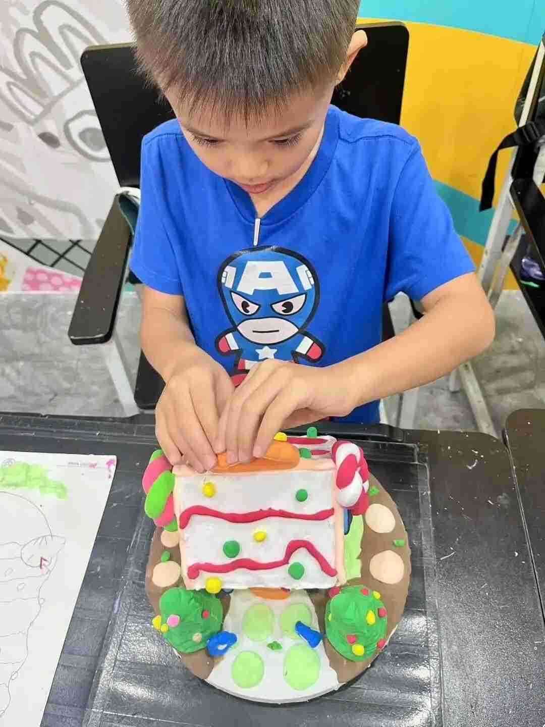 TreeArt student displaying a finished piece of artwork