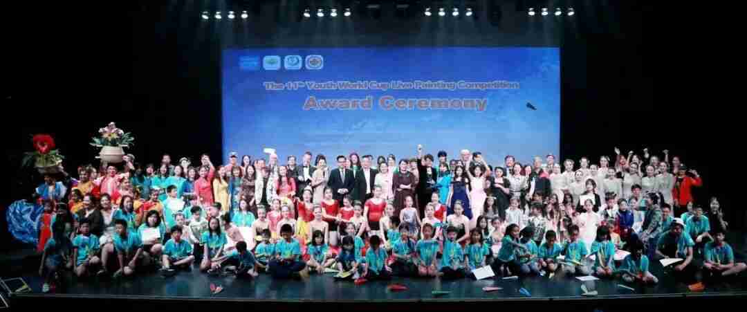Winners and organizers on stage at the Youth World Cup Live Painting Competition award ceremony
