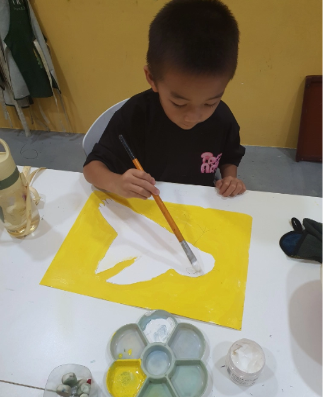 TreeArt student giving careful, hands-on attention to a drawing